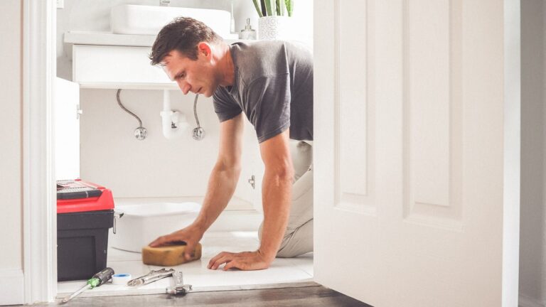 water damage restoration specialist cleaning up water damage on floor